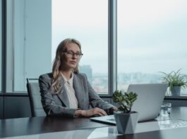 Sharply dressed real estate investor using her laptop to explore business opportunities